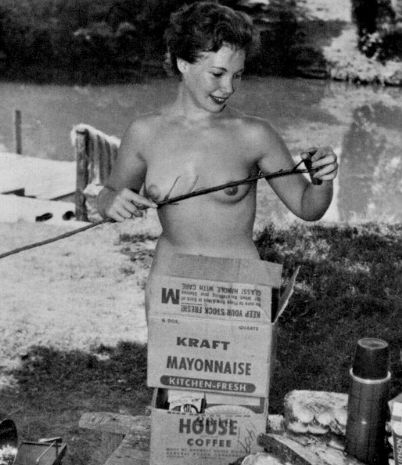 nude with bare titties roasting a hot dog